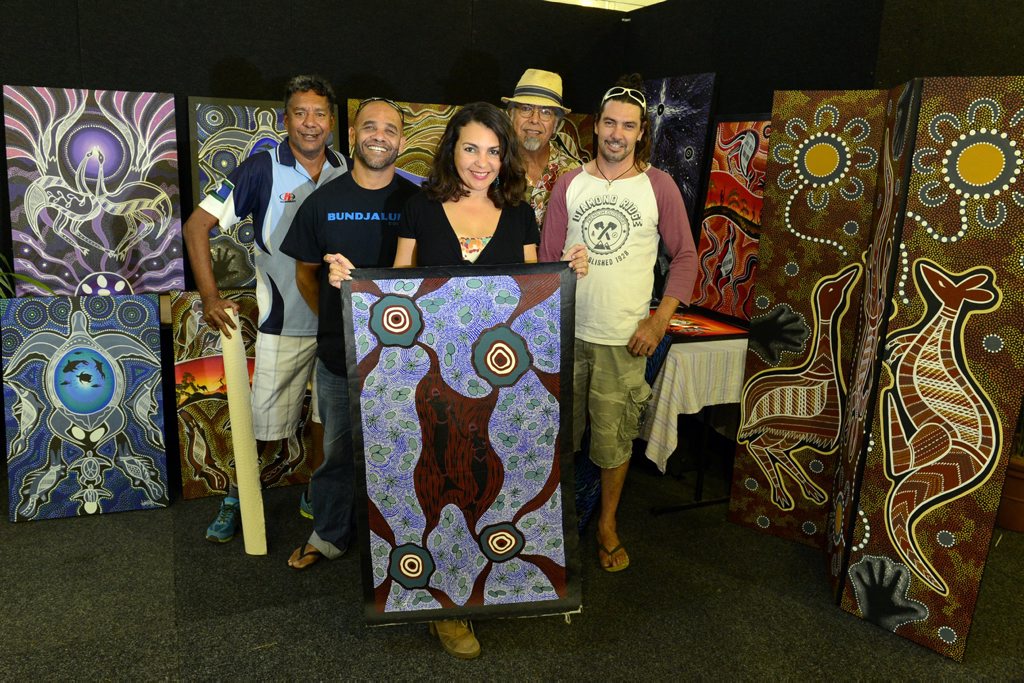Artwork curated by Indijnarts line the walls in the Artist area at the Bluesfest site. From left are, Winjella, Kagaru, Amanda Manton, John Pene-Formosa, and Munn. Amanda holds artwork Fish Man by Karen Doolan. Photo Cathy Adams / The Northern Star Artwork curated by Indijnarts line the walls in the Artist area at the Bluesfest site. From left are, Winjella, Kagaru, Amanda Manton, John Pene-Formosa, and Munn. Amanda holds artwork Fish Man by Karen Doolan. Photo Cathy Adams / The Northern Star