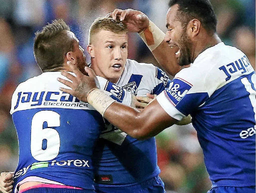 Trent Hodkinson (centre) celebrates with Bulldogs team mates Josh Reynolds (left) and Tony Williams. Trent Hodkinson (centre) celebrates with Bulldogs team mates Josh Reynolds (left) and Tony Williams.