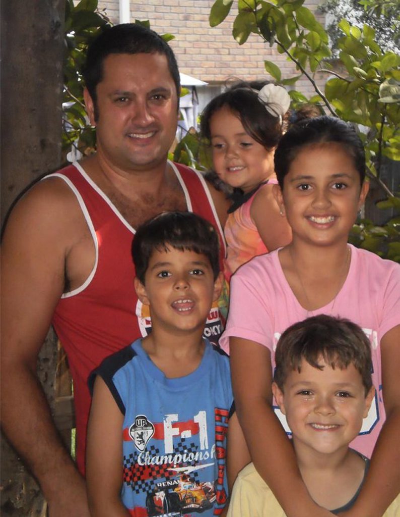 New Zealander Tim Baker with his children (from left) Aramiha, Yolanda (rear), Penelope and Albert at their Gold Coast home.