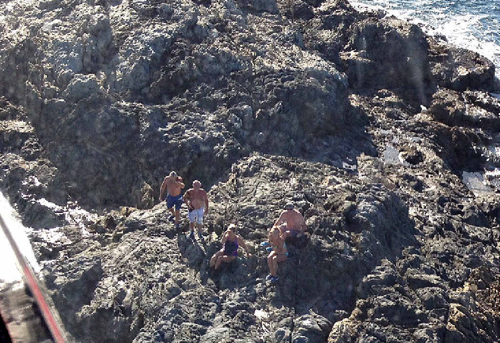 Stranded boaties waiting to be winched by the RACQ CQ Rescue helicopter. Stranded boaties waiting to be winched by the RACQ CQ Rescue helicopter.