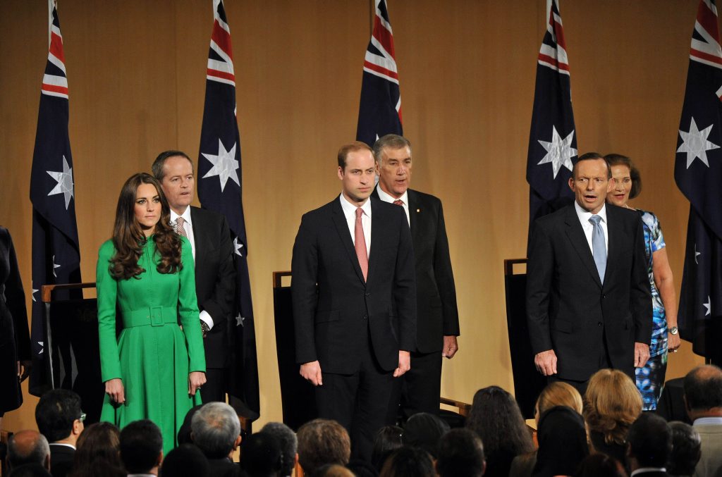 Britain's Prince William (front C) and his wife Catherine, Duchess of Cambridge (R), stand with Australia's Prime Minister Tony Abbott (front R) as they sing the national anthem during a reception at Parliament House in Canberra on April 24, 2014. Britain's Prince William (front C) and his wife Catherine, Duchess of Cambridge (R), stand with Australia's Prime Minister Tony Abbott (front R) as they sing the national anthem during a reception at Parliament House in Canberra on April 24, 2014.