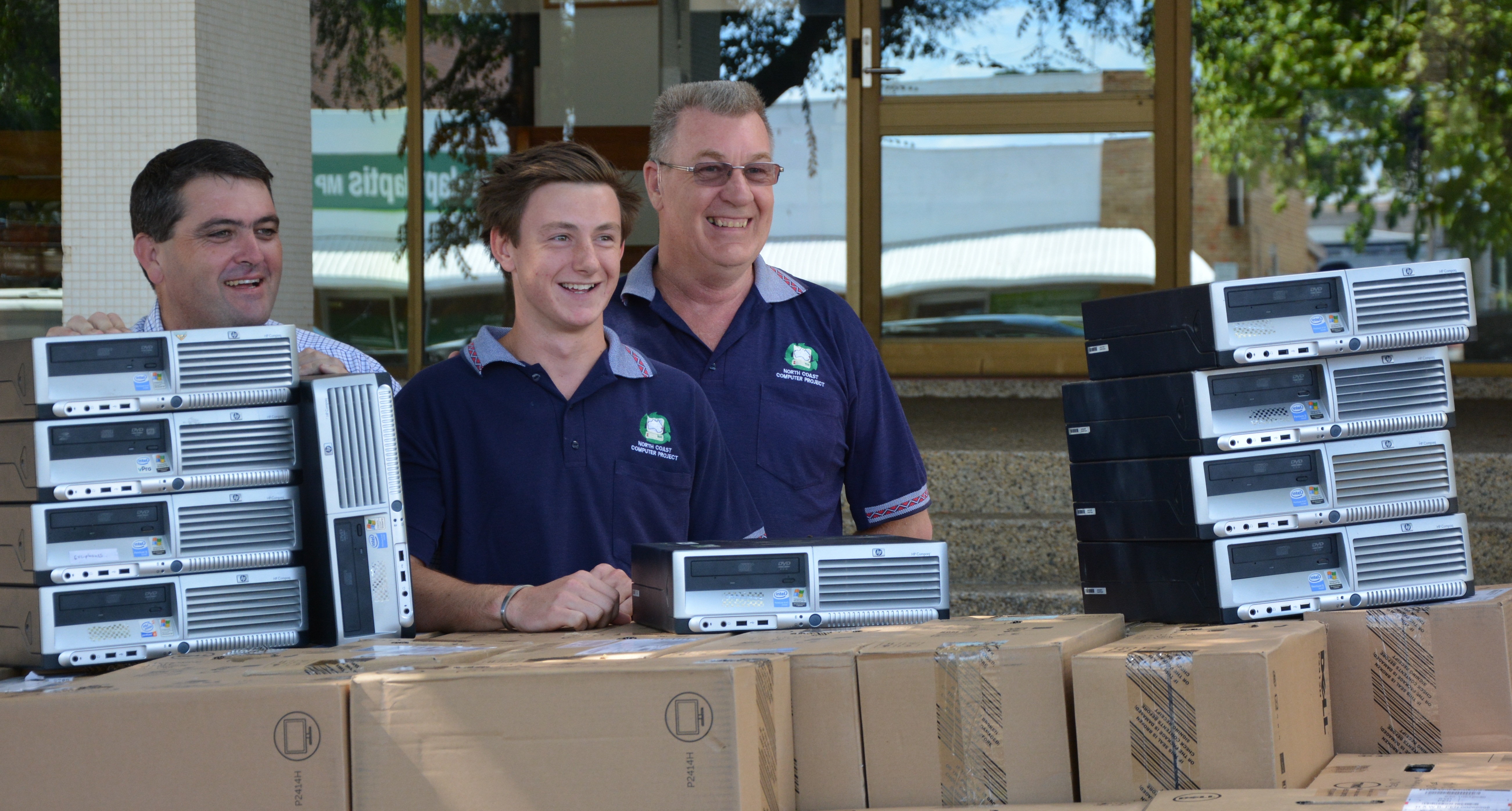 Mayor Richie Williamson sorts through the computers with TAFE student Thomas Billett and project manager Bernie Francis. Mayor Richie Williamson sorts through the computers with TAFE student Thomas Billett and project manager Bernie Francis.