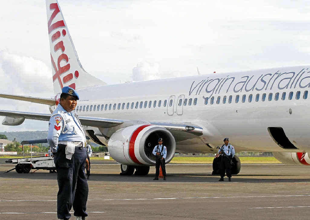 Indonesian Air Force personnel stand guard by Virgin Australia Flight VA41. Indonesian Air Force personnel stand guard by Virgin Australia Flight VA41.