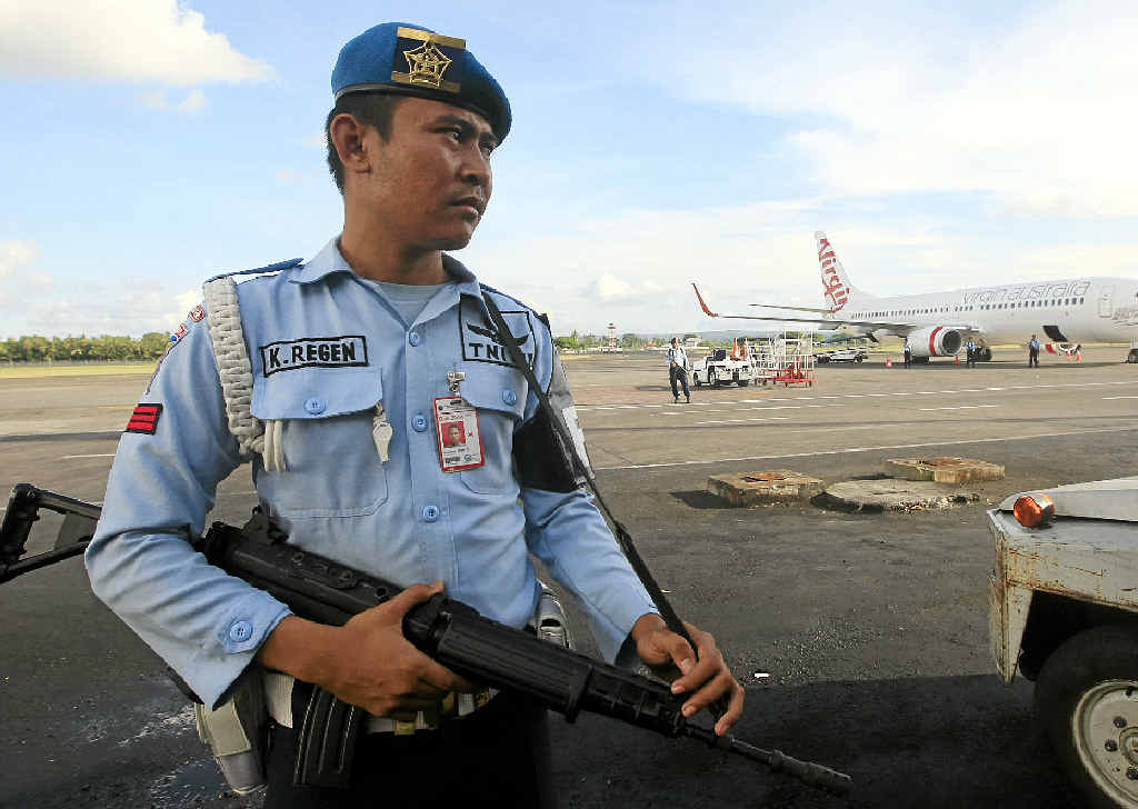 ON ALERT: An Indonesian Air Force member stands guard near a Virgin Australia airplane in Bali, Indonesia, yesterday. ON ALERT: An Indonesian Air Force member stands guard near a Virgin Australia airplane in Bali, Indonesia, yesterday.