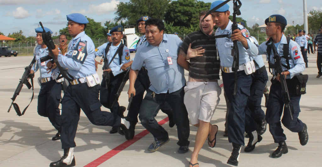WRONG DOOR: Indonesian Air Force soldiers rush Matt Lockley from a Virgin Australia plane at Ngurah Rai airport in Denpasar. WRONG DOOR: Indonesian Air Force soldiers rush Matt Lockley from a Virgin Australia plane at Ngurah Rai airport in Denpasar.