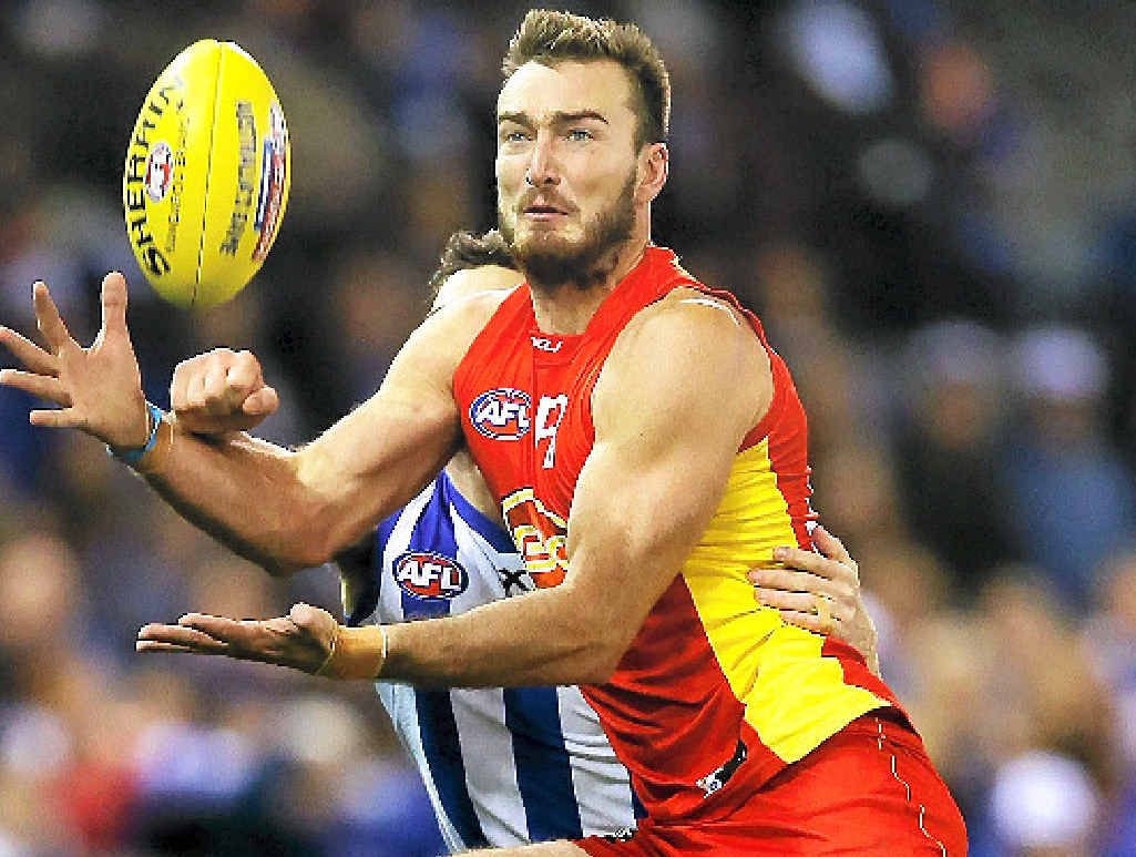 Charlie Dixon of the Suns gets set to mark against the Kangaroos. Charlie Dixon of the Suns gets set to mark against the Kangaroos.