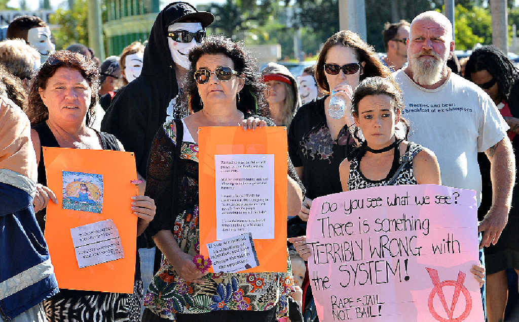 More than 60 people gather outside the Mackay Courthouse with members of Anonymous Mackay, in a protest against two police receiving bail over the alleged rape of a woman. More than 60 people gather outside the Mackay Courthouse with members of Anonymous Mackay, in a protest against two police receiving bail over the alleged rape of a woman.