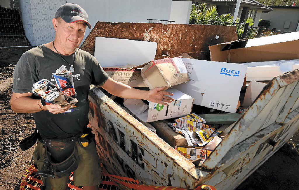 MONEY WASTE: Planet Homes employee Raoul Resser with one of the skips filled with other people’s junk, which his boss, Jason Bowker, has to pay to dump. MONEY WASTE: Planet Homes employee Raoul Resser with one of the skips filled with other people’s junk, which his boss, Jason Bowker, has to pay to dump.