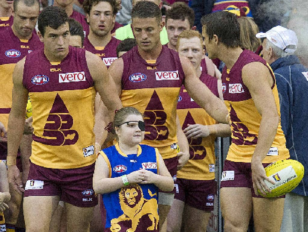 Tobi Wilkinson (centre) prepares to run on to the field with the Brisbane Lions. Tobi Wilkinson (centre) prepares to run on to the field with the Brisbane Lions.