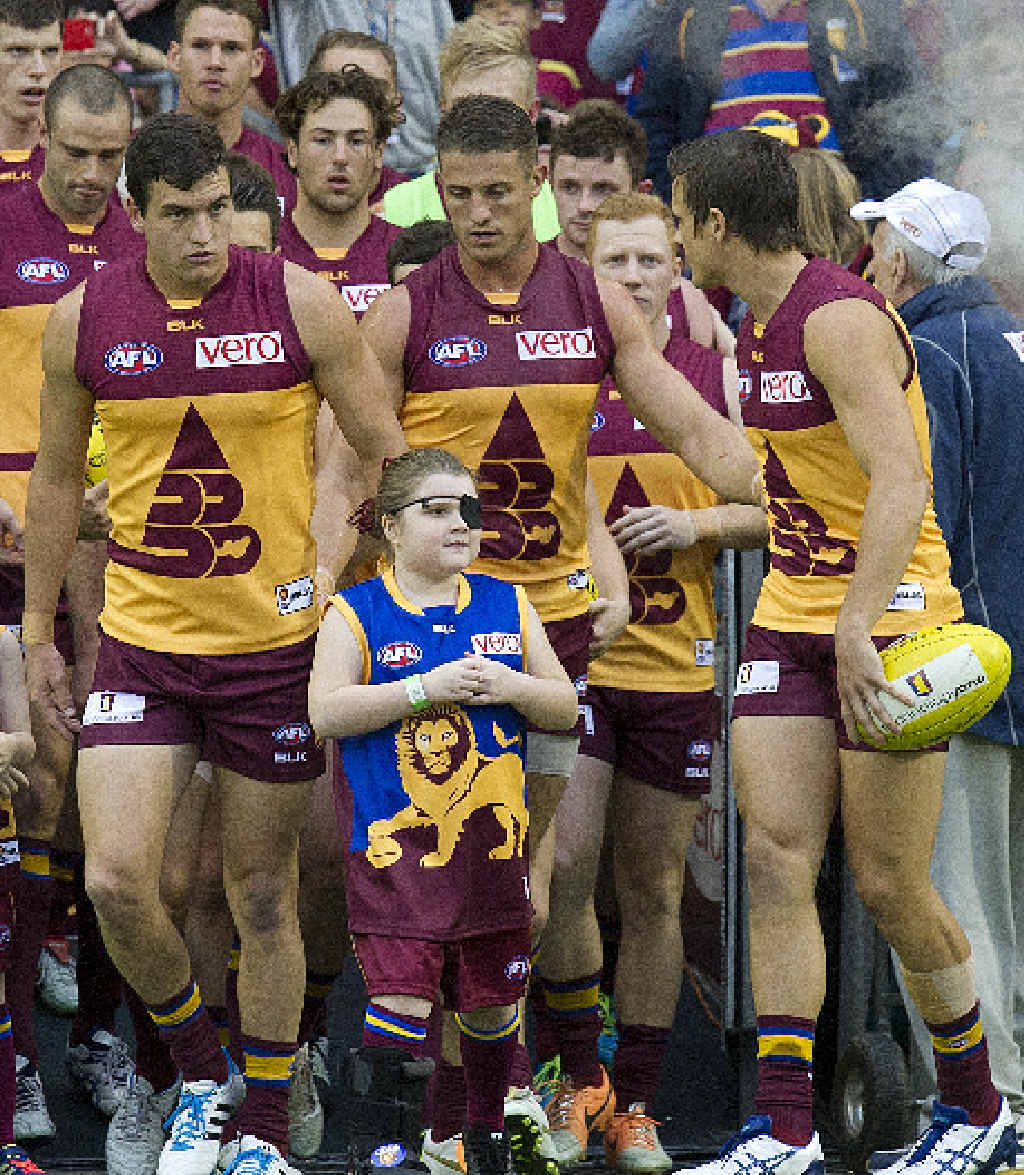 Tobi Wilkinson (centre) prepares to run on to the field with the Brisbane Lions. Tobi Wilkinson (centre) prepares to run on to the field with the Brisbane Lions.