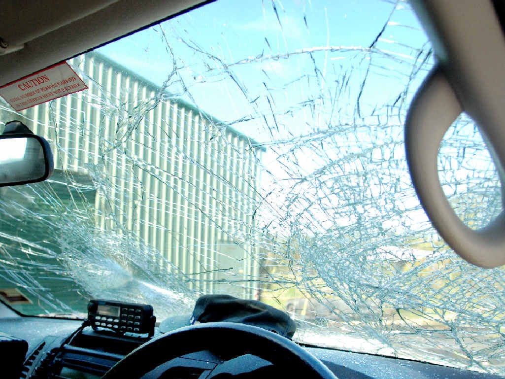 PARTY DAMAGE: Two cars were torched and this second police vehicle that was pelted with bricks, pavers and bottles. PARTY DAMAGE: Two cars were torched and this second police vehicle that was pelted with bricks, pavers and bottles.