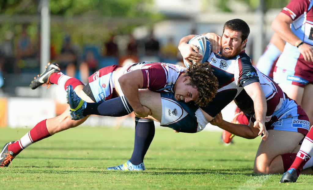 PLAYING ROUGH: Capras player Peter Gallen is tackled in the match against the Mackay Cutters on Anzac Day. PLAYING ROUGH: Capras player Peter Gallen is tackled in the match against the Mackay Cutters on Anzac Day.