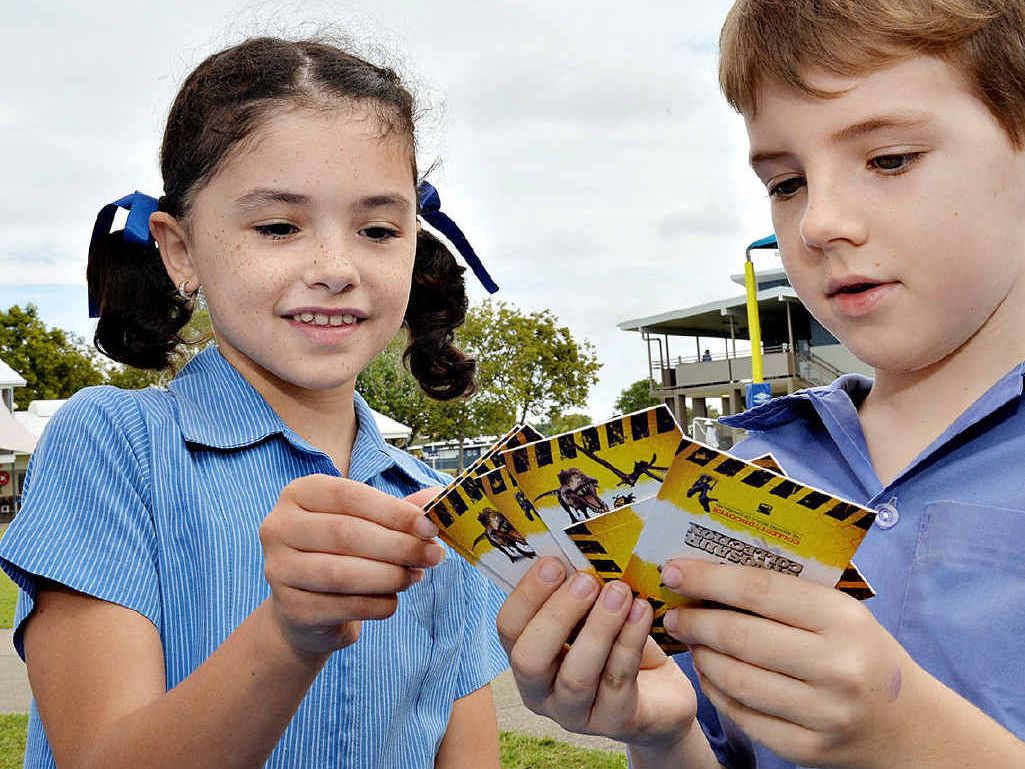 DINO FANS: Tyla Saron and Travis Lynch check out the cards.