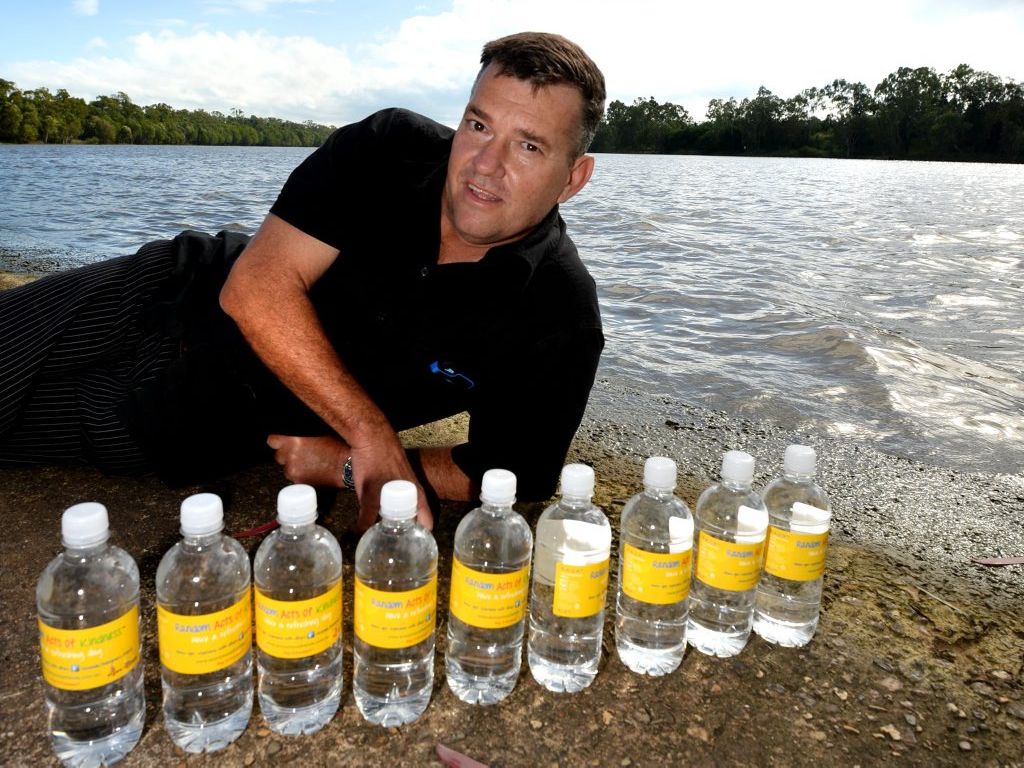 Mark Ricks with bottles of water branded as Random Act of kindness. Photo Allan Reinikka / The Morning Bulletin Mark Ricks with bottles of water branded as Random Act of kindness. Photo Allan Reinikka / The Morning Bulletin
