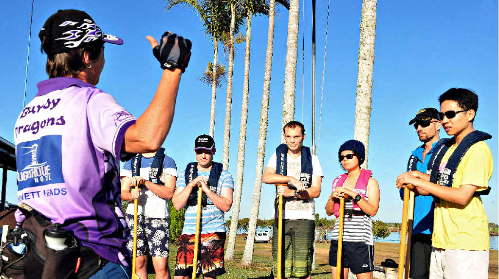 ALL EARS: Sharyn Smith from the Bundaberg Dragon Boat Club gives QUT students some important safety tips before they head out for a paddle. The outing was the club’s way of thanking the students for their help after the floods.