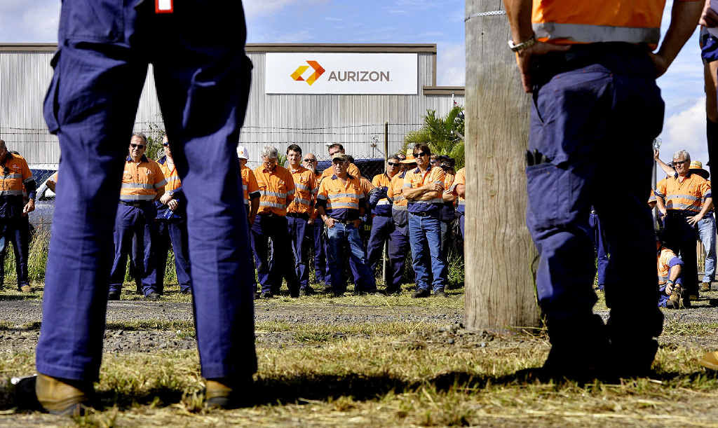 GRIM: Aurizon workers at the Redbank workshops listen to union delegates at a meeting yesterday. Aurizon will shed 450 workers by June 2015. GRIM: Aurizon workers at the Redbank workshops listen to union delegates at a meeting yesterday. Aurizon will shed 450 workers by June 2015.