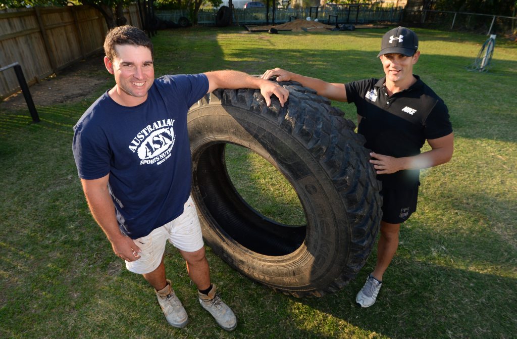 Chris Bath (left) lost 18kg in 10 weeks with the help of his trainer and brother Damien Bath and a rather large truck tyre he flipped up and down the yard among other activities. Photo: Chris Ison / The Morning Bulletin Chris Bath (left) lost 18kg in 10 weeks with the help of his trainer and brother Damien Bath and a rather large truck tyre he flipped up and down the yard among other activities. Photo: Chris Ison / The Morning Bulletin