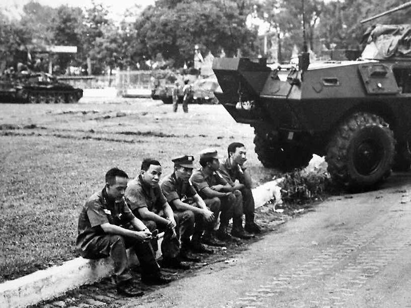 South Vietnamese officers sit dejectedly on a curb outside the Presidential Palace shortly after North Vietnamese troops captured the Palace in Saigon on April 30, 1975. South Vietnamese officers sit dejectedly on a curb outside the Presidential Palace shortly after North Vietnamese troops captured the Palace in Saigon on April 30, 1975.
