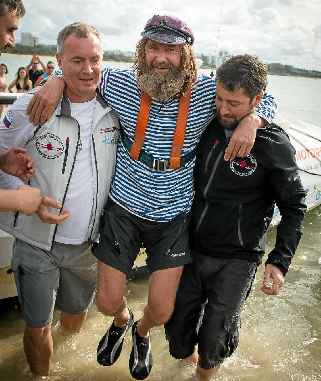 SEA LEGS: Mr Konyukhov is helped ashore at the Mooloolaba Spit, his first time on land since December. SEA LEGS: Mr Konyukhov is helped ashore at the Mooloolaba Spit, his first time on land since December.