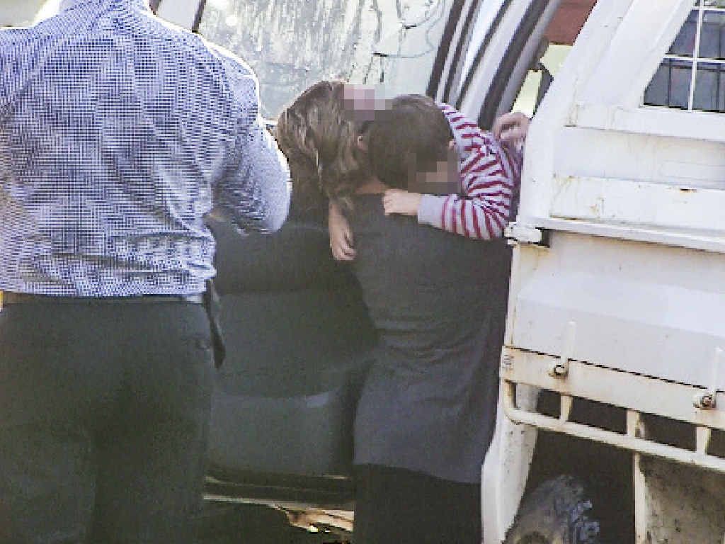 HUG OF RELIEF: Mother and son cling to each other in South Grafton yesterday. HUG OF RELIEF: Mother and son cling to each other in South Grafton yesterday.