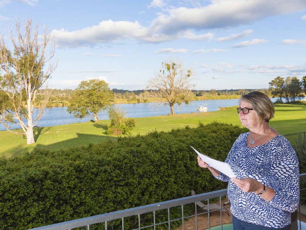 WATER TORTURE: Helen Hearnshaw, on the balcony of her house high above the Grafton levy, is trying to work out how she can avoid a huge insurance increase that would take her annual premiums to almost $10,000. WATER TORTURE: Helen Hearnshaw, on the balcony of her house high above the Grafton levy, is trying to work out how she can avoid a huge insurance increase that would take her annual premiums to almost $10,000.
