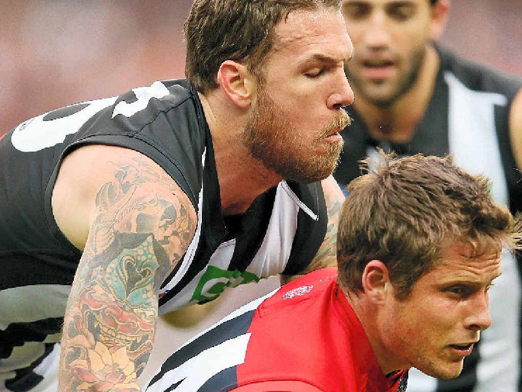 BAIL DENIED: Dane Swan of the Magpies tackles Rohan Bail of the Demons at the Melbourne Cricket Ground yesterday. BAIL DENIED: Dane Swan of the Magpies tackles Rohan Bail of the Demons at the Melbourne Cricket Ground yesterday.