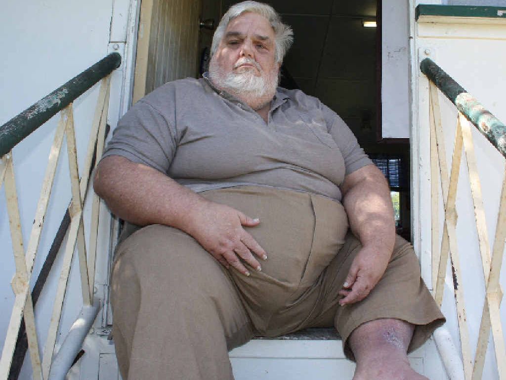 Koongal resident Joel Adams sits in his doorway pondering his future after his father’s house is sold. Koongal resident Joel Adams sits in his doorway pondering his future after his father’s house is sold.