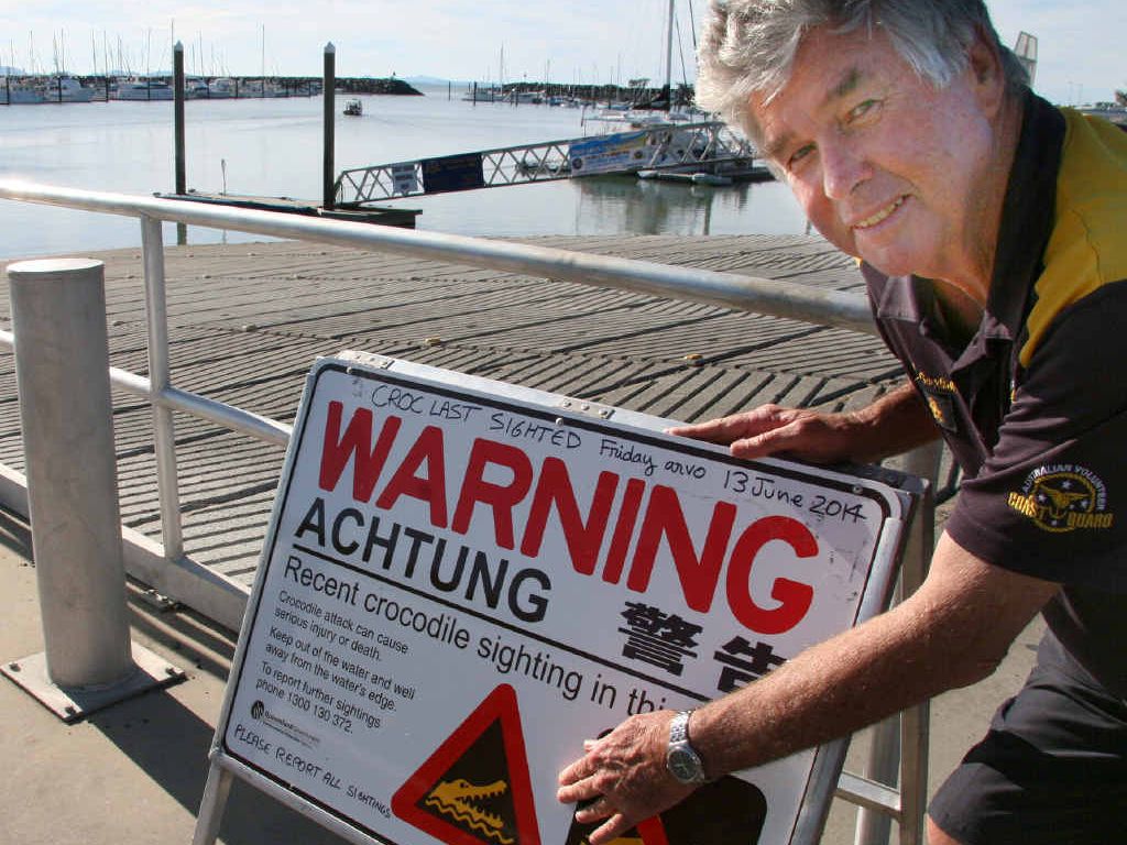 CROC WATCH: Yeppoon Coast Guard Deputy Commander Jim Goodsell, with the crocodile alert sign, says people should proceed with caution in the Rosslyn Bay harbour after a croc was spotted last Friday. CROC WATCH: Yeppoon Coast Guard Deputy Commander Jim Goodsell, with the crocodile alert sign, says people should proceed with caution in the Rosslyn Bay harbour after a croc was spotted last Friday.