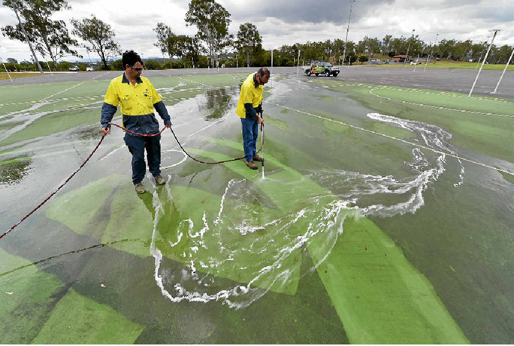 EXPENSIVE MESS: Council workers use a high-pressure hose to clean graffiti at Doris Howes netball courts. EXPENSIVE MESS: Council workers use a high-pressure hose to clean graffiti at Doris Howes netball courts.
