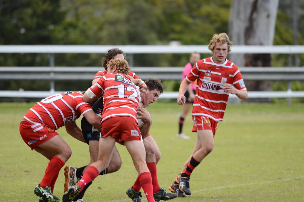 Lower Clarence Magpie Tym Peters is smashed by the Byron Bay defence in Saturday's NRRRL game. 