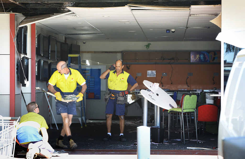 ALL BETS OFF: Workers clean up the damaged TAB in the St Ives Shopping Centre in Goodna after a car ploughed through it. ALL BETS OFF: Workers clean up the damaged TAB in the St Ives Shopping Centre in Goodna after a car ploughed through it.