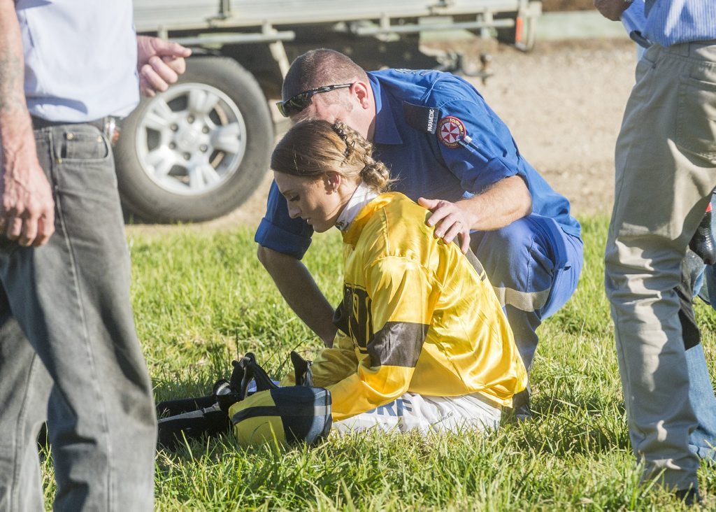 Jockey Cassandra Schmidt treated on course after a fall in race 6 on Westlawn day brought down three jockeys. Photo: Adam Hourigan / The Daily Examiner Jockey Cassandra Schmidt treated on course after a fall in race 6 on Westlawn day brought down three jockeys. Photo: Adam Hourigan / The Daily Examiner