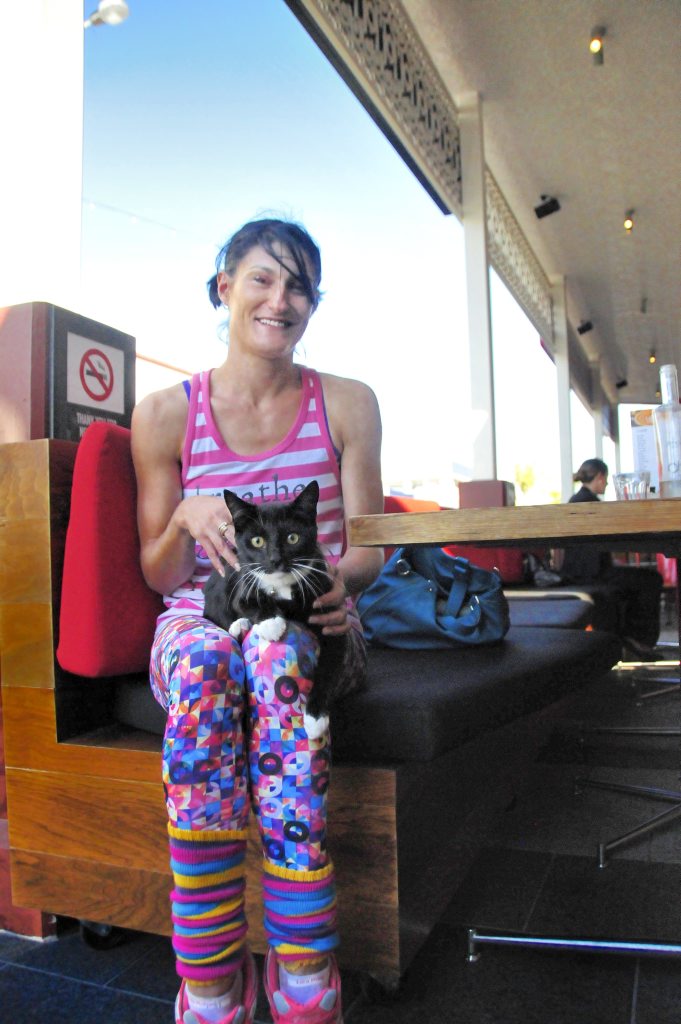 SURPRISE: Jactinta Hinton with the cat she rescued after it jumped from a moving car on Goondoon St. SURPRISE: Jactinta Hinton with the cat she rescued after it jumped from a moving car on Goondoon St.