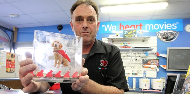 Kevin Knox, owner of Video Ezy Greenmeadows in New Zealand's Napier, with a charity donation box for the Royal New Zealand Foundation for the Blind, which a Video Ezy member allegedly tried to steal at the weekend. He was thwarted by the Velcro dots attaching the box to the counter. Kevin Knox, owner of Video Ezy Greenmeadows in New Zealand's Napier, with a charity donation box for the Royal New Zealand Foundation for the Blind, which a Video Ezy member allegedly tried to steal at the weekend. He was thwarted by the Velcro dots attaching the box to the counter.