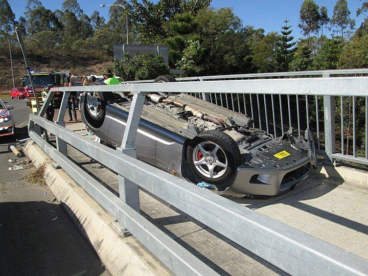 LUCKY ESCAPE: The car came to rest in an unlikely position on a bridge in Springfield Central. LUCKY ESCAPE: The car came to rest in an unlikely position on a bridge in Springfield Central.