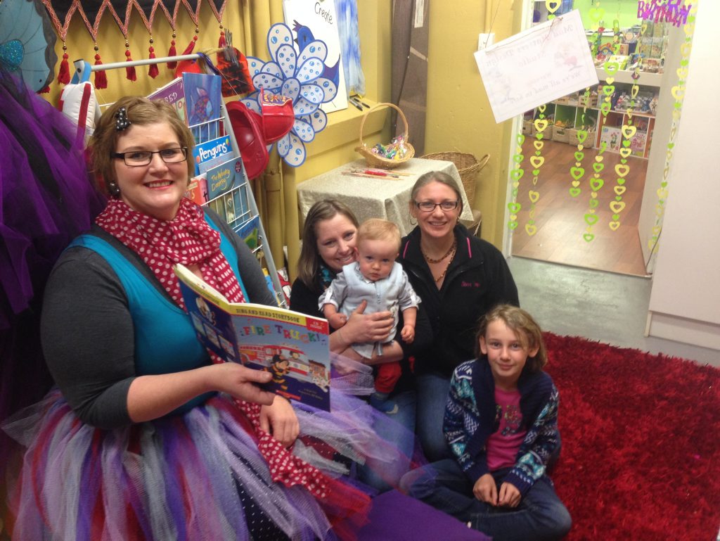 Getting into a good book at Story Time at Savvy Toys are Denise Patterson, Genevieve Ashby, Kye lamb, Lucy Halliday and Haylee Halliday.
