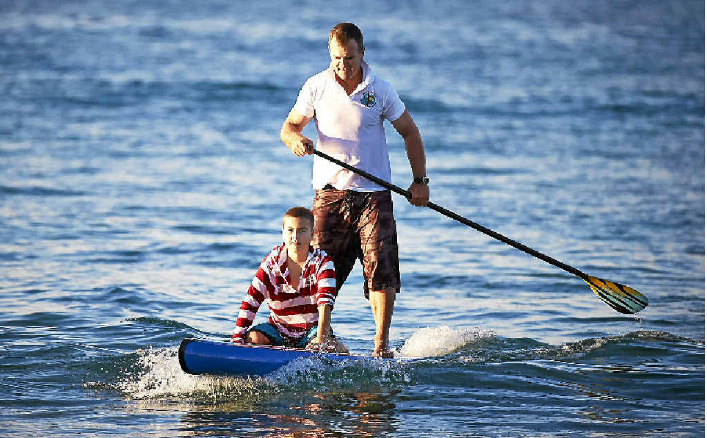 LONG PADDLE: Andy Owen and 12-year-old leukemia sufferer Xavier Slezak. LONG PADDLE: Andy Owen and 12-year-old leukemia sufferer Xavier Slezak.