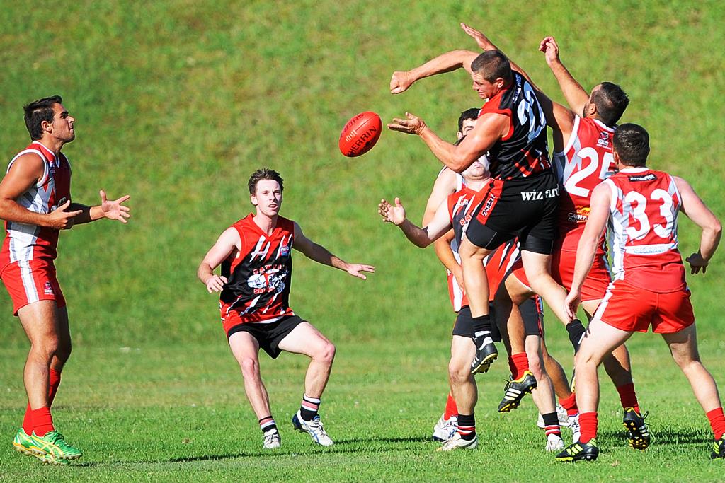 Sawtell/Toormina's Mark Couzens gets a handball away despite pressure from the Coffs Swans opposition. Photo: Leigh jensen / Coffs Coast Advocate Sawtell/Toormina's Mark Couzens gets a handball away despite pressure from the Coffs Swans opposition. Photo: Leigh jensen / Coffs Coast Advocate