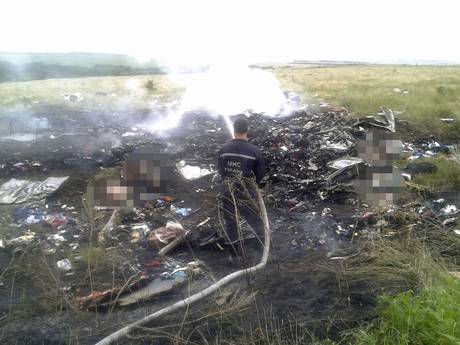 A man works at putting out a fire at the site of the plane crash A man works at putting out a fire at the site of the plane crash