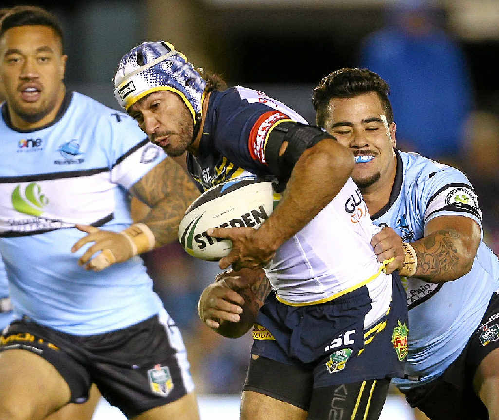 ON THE RUN: Johnathan Thurston of the Cowboys makes a break from the grasp of Andrew Fifita of the Sharks at Remondis Stadium in Sydney last night. ON THE RUN: Johnathan Thurston of the Cowboys makes a break from the grasp of Andrew Fifita of the Sharks at Remondis Stadium in Sydney last night.