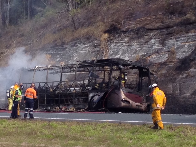 Firefighters at the aftermath of the school bus fire on the Bruce Highway. Firefighters at the aftermath of the school bus fire on the Bruce Highway.
