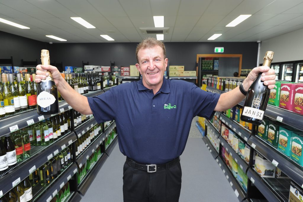 Graham Smyth at his new job in the bottle shop at the Beach House Hotel - the unemployed man had been standing beside the road with a sign looking for work for the past few weeks. Graham Smyth at his new job in the bottle shop at the Beach House Hotel - the unemployed man had been standing beside the road with a sign looking for work for the past few weeks.