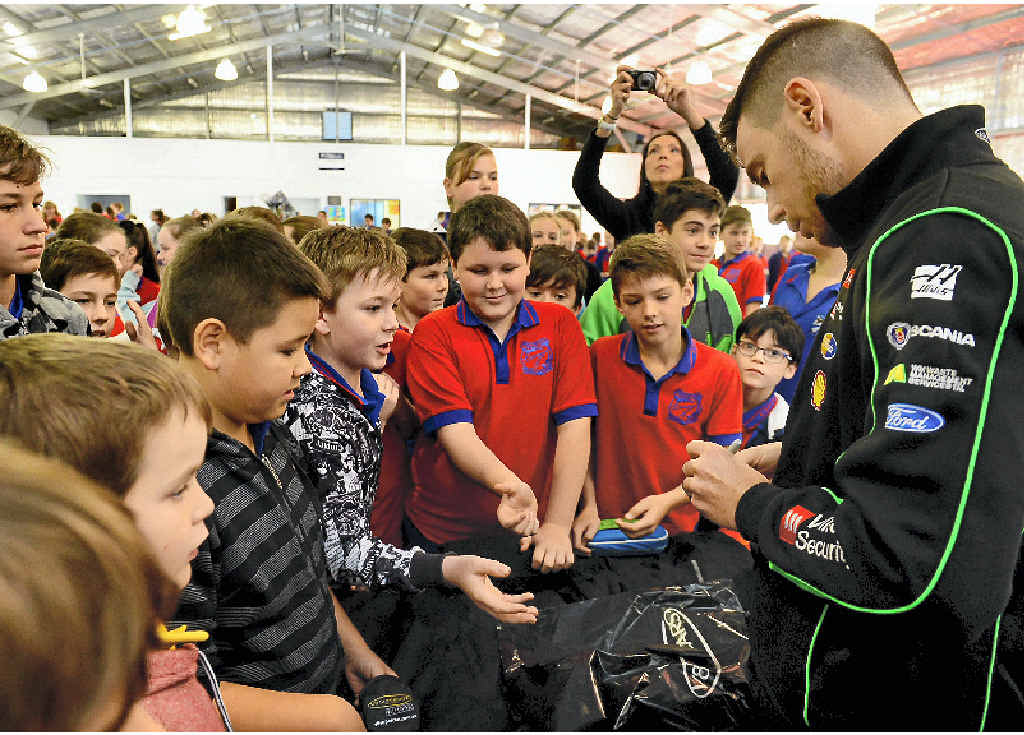 AUTOGRAPH HUNTERS: V8 Supercars star Scott Pye signs items for Karalee State School students. AUTOGRAPH HUNTERS: V8 Supercars star Scott Pye signs items for Karalee State School students.