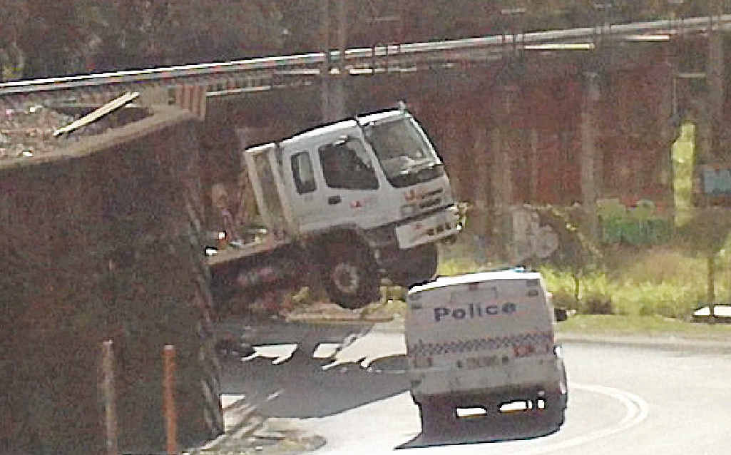 WHEELSTAND: The garbage truck snagged by the Blackall St underpass at Woombye. WHEELSTAND: The garbage truck snagged by the Blackall St underpass at Woombye.