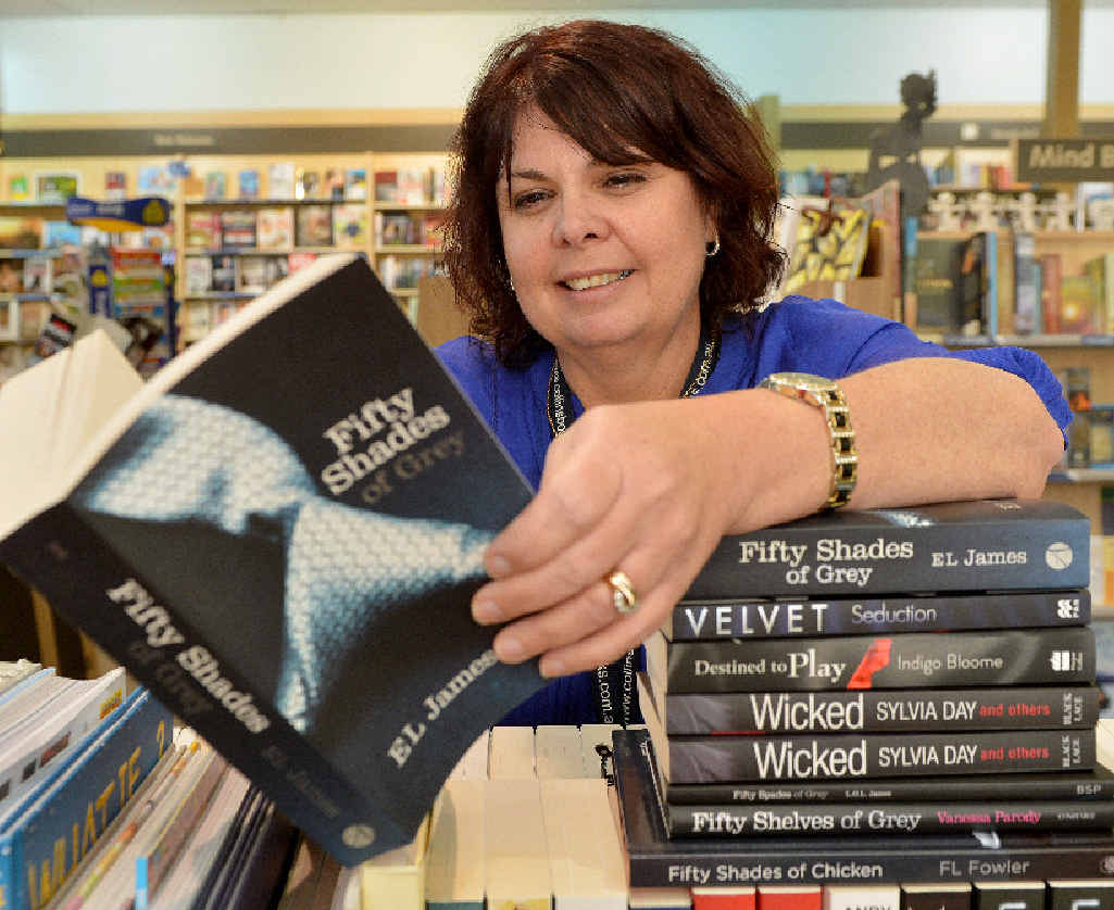 Karen Gampe of Collins Booksellers at Sydney St Markets with the erotica novel Fifty Shades of Grey. Karen Gampe of Collins Booksellers at Sydney St Markets with the erotica novel Fifty Shades of Grey.