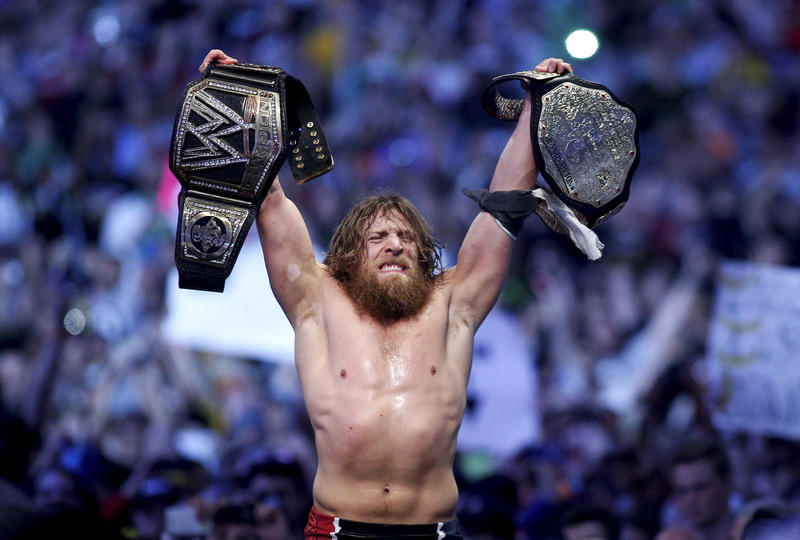This April 6, 2014 photo provided by the WWE shows Daniel Bryan celebrating after winning the main event during Wrestlemania XXX at the Mercedes-Benz Super Dome in New Orleans. Police say the former WWE champion, Bryan chased two burglary suspects he saw exiting his Phoenix home this week and subdued one until officers arrived. This April 6, 2014 photo provided by the WWE shows Daniel Bryan celebrating after winning the main event during Wrestlemania XXX at the Mercedes-Benz Super Dome in New Orleans. Police say the former WWE champion, Bryan chased two burglary suspects he saw exiting his Phoenix home this week and subdued one until officers arrived.