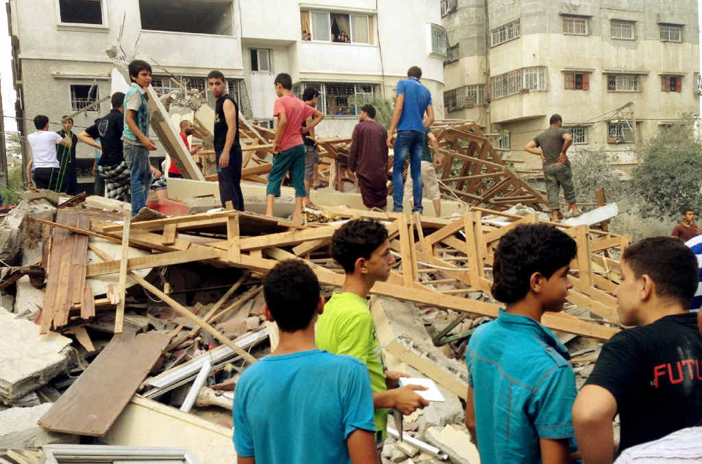 AFTERMATH: Palestinians inspect the rubble after buildings are left in ruins by an Israeli missile. Photo: Aaron Hollett - ABC News AFTERMATH: Palestinians inspect the rubble after buildings are left in ruins by an Israeli missile. Photo: Aaron Hollett - ABC News