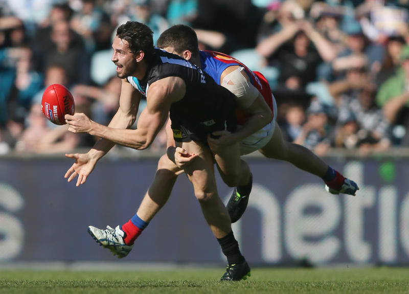 John Butcher of Port Adelaide looks to hand ball before being tackled by Jack Crisp of the Brisbane Lions during the Round 18 AFL match between the Port Adelaide Power and the Brisbane Lions at AAMI Stadium in Adelaide, Sunday, July 28, 2013. John Butcher of Port Adelaide looks to hand ball before being tackled by Jack Crisp of the Brisbane Lions during the Round 18 AFL match between the Port Adelaide Power and the Brisbane Lions at AAMI Stadium in Adelaide, Sunday, July 28, 2013.