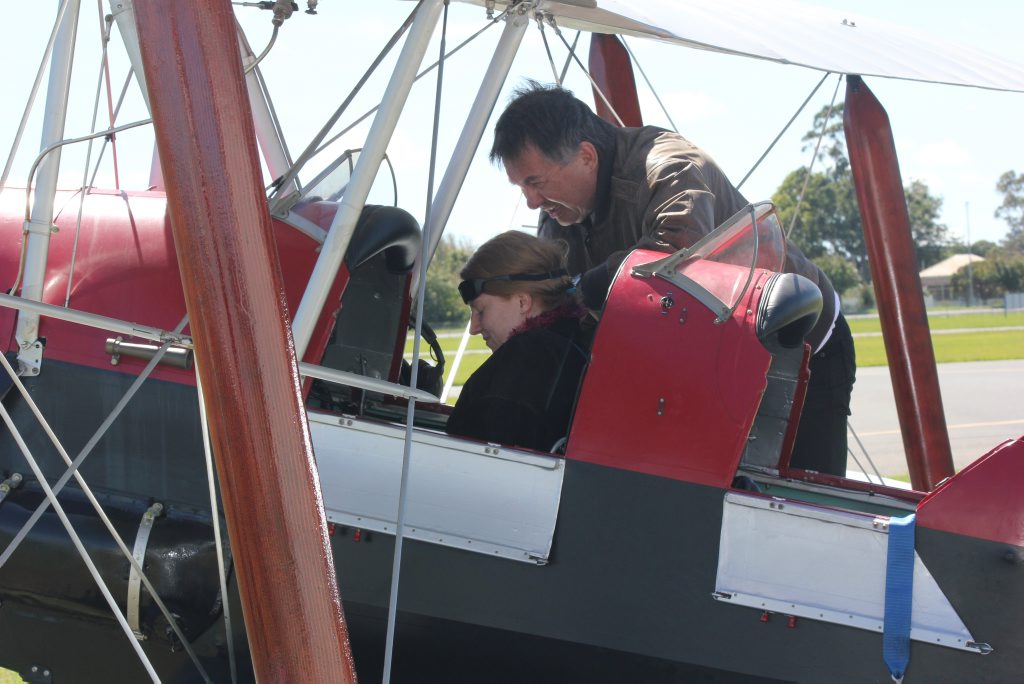 Former Solicitor-General Walter Sofronoff secures family friend Erin Miller into a 1939 De Havilland Tiger Moth at Toowoomba Airport earlier this year. Former Solicitor-General Walter Sofronoff secures family friend Erin Miller into a 1939 De Havilland Tiger Moth at Toowoomba Airport earlier this year.
