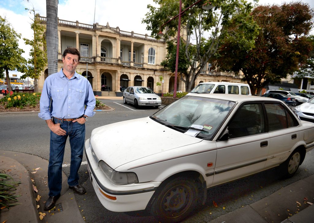 Mark Woods with the 1996 Holden Nova that has been parked on East Street for five months. Photo Allan Reinikka / The Morning Bulletin Mark Woods with the 1996 Holden Nova that has been parked on East Street for five months. Photo Allan Reinikka / The Morning Bulletin
